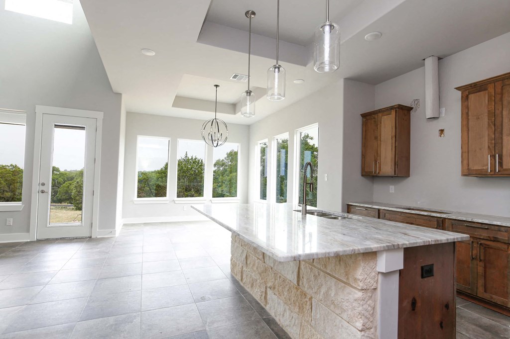 a large kitchen with a large marble counter top