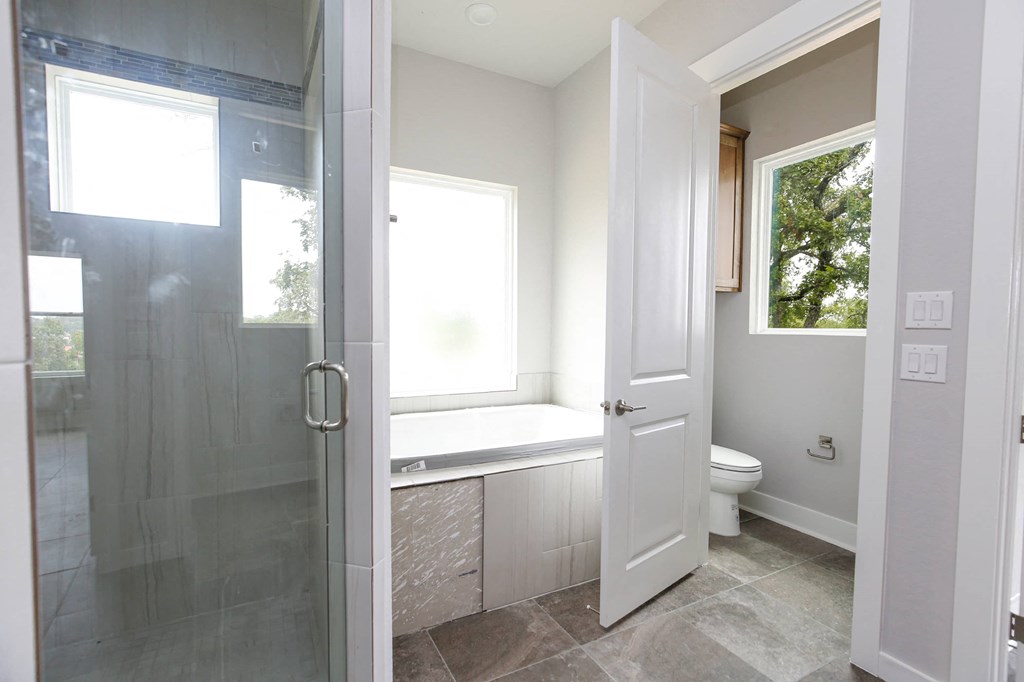 a bathroom with a shower and a sink and a toilet