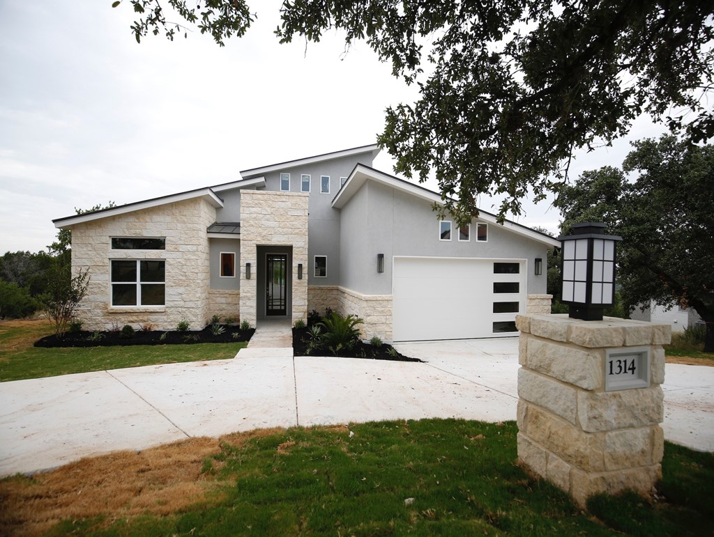 a white house with a driveway and a white garage door