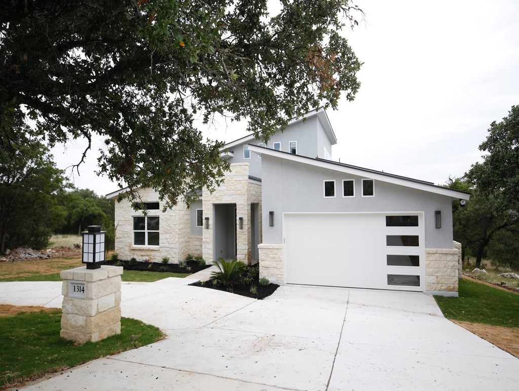 a white house with a driveway and a white garage door