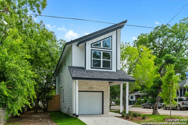 a small gray and with a garage