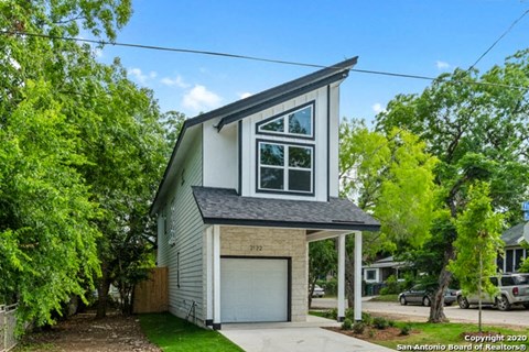 a small gray and with a garage