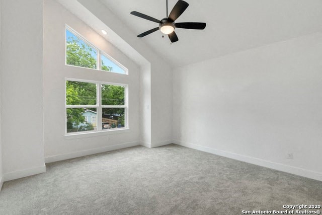 an empty room with a ceiling fan and a window