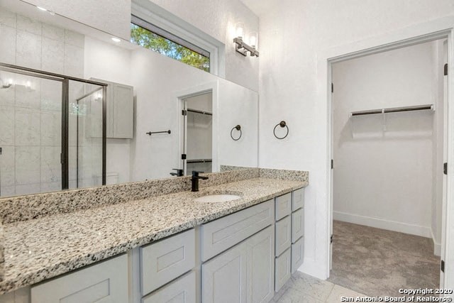 a white bathroom with a sink and a mirror