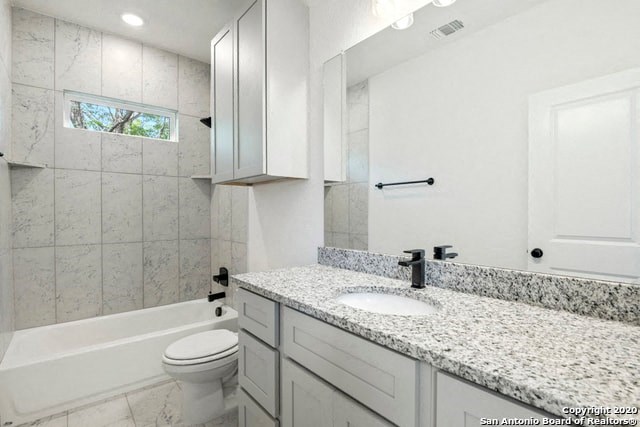 a white bathroom with a sink and a toilet