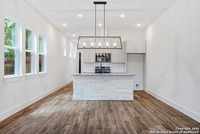 a kitchen with a large island in the middle of it