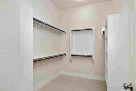 a laundry room with two hanging racks and a white door