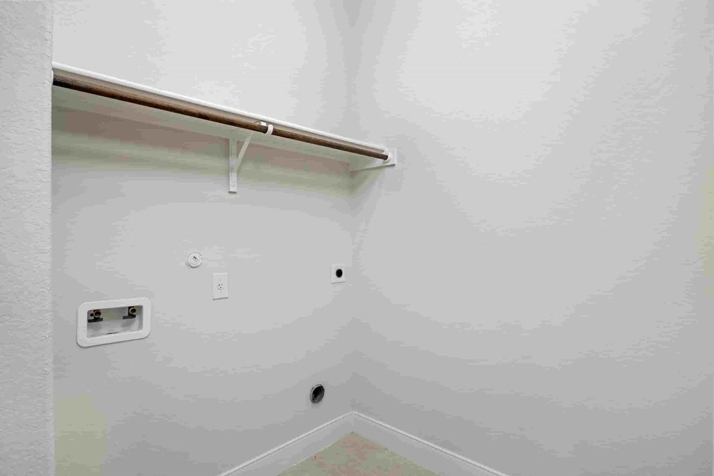 an empty room with a wall with a light and a wall bracket on the ceiling