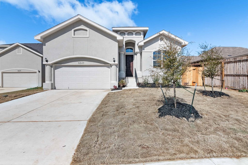 a house with a driveway and a garage door