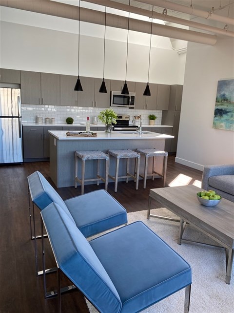 A modern kitchen with a dining table and chairs.