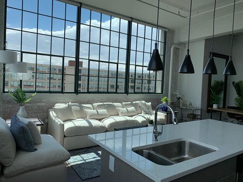 A modern kitchen with a large window overlooking the city.