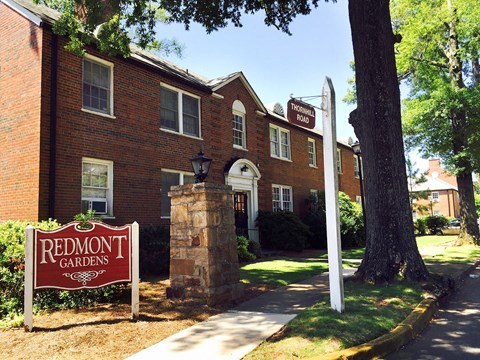 a redmont gardens sign in front of a brick building