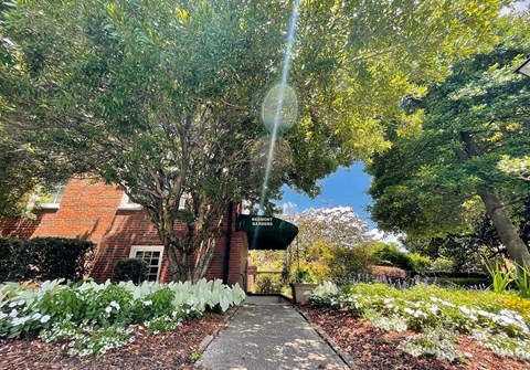 a garden in front of a brick building