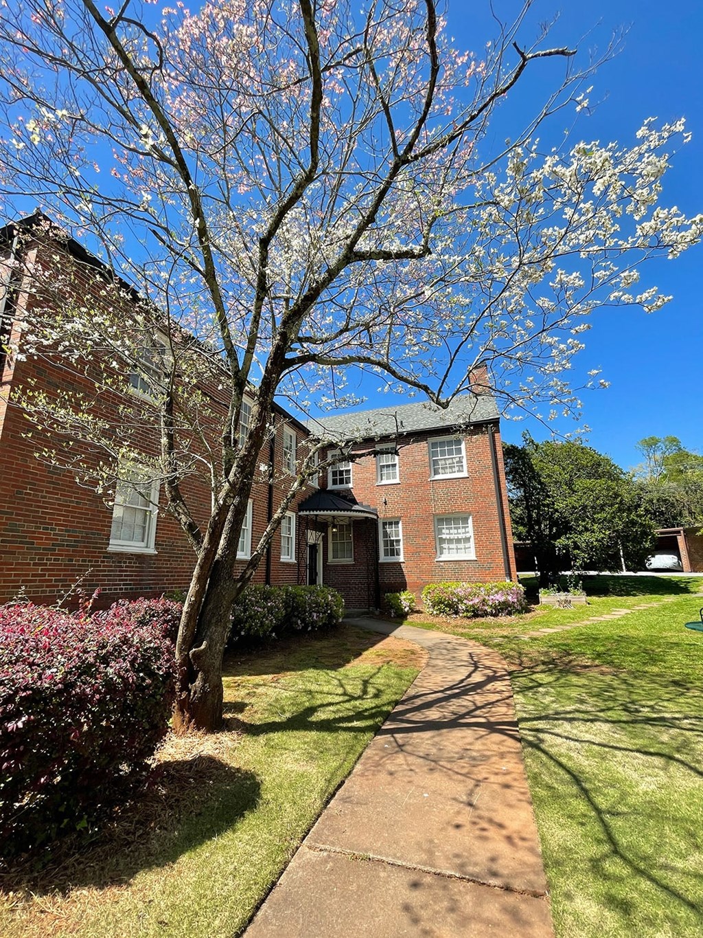 a brick building with a tree in front of it