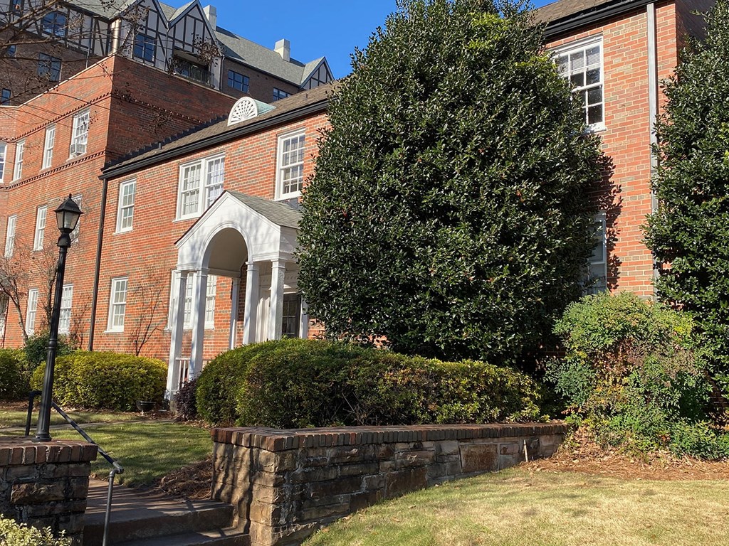 a brick building with a tree in front of it