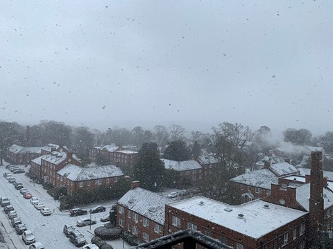 a view of a snow covered city from a window
