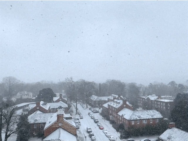 a town with snow on the roofs of houses