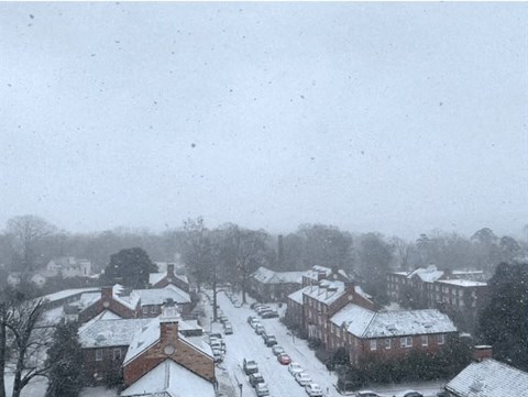a town with snow on the roofs of houses