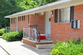 a bike parked on the front porch of a brick house