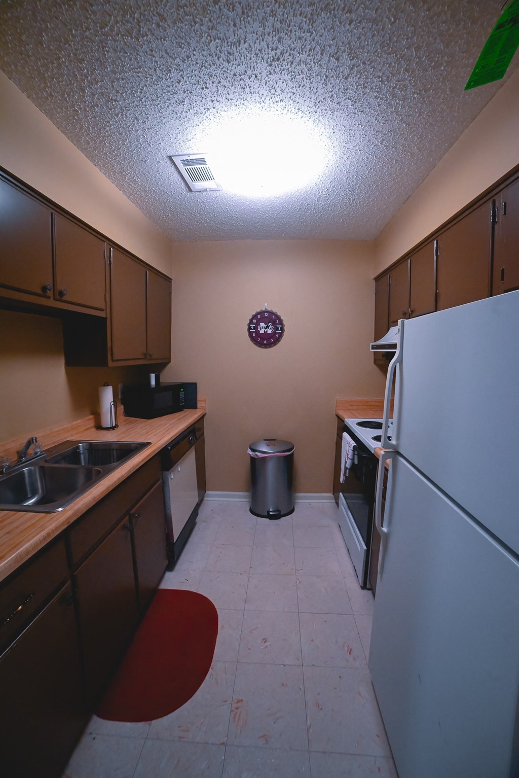 a kitchen with a sink and a refrigerator