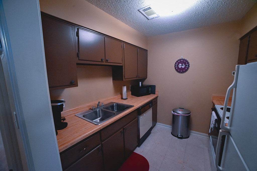 a kitchen with a sink and a refrigerator