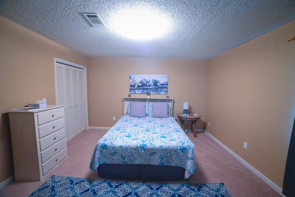 a bedroom with a bed and a closet