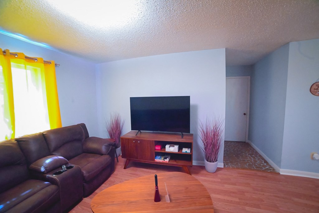 a living room with leather couches and a television