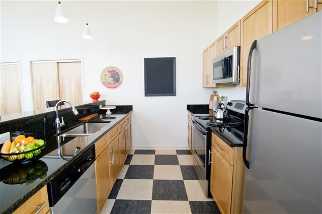 A black and white checkered floor in a kitchen.