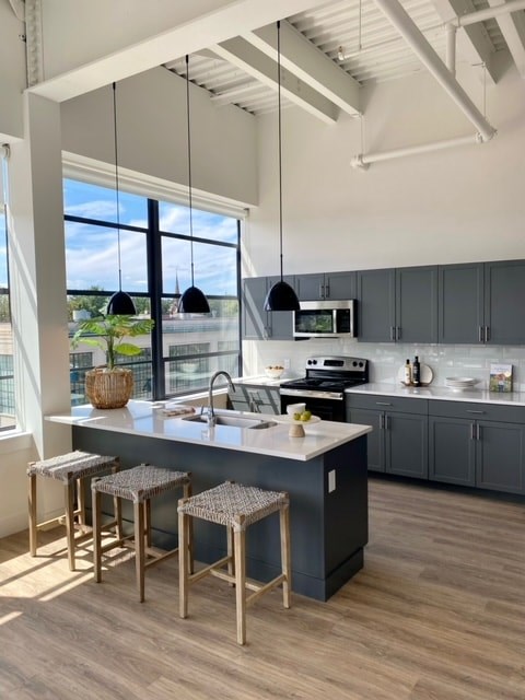 a kitchen with a large island and some stools