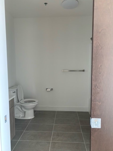 a bathroom with a toilet and a door