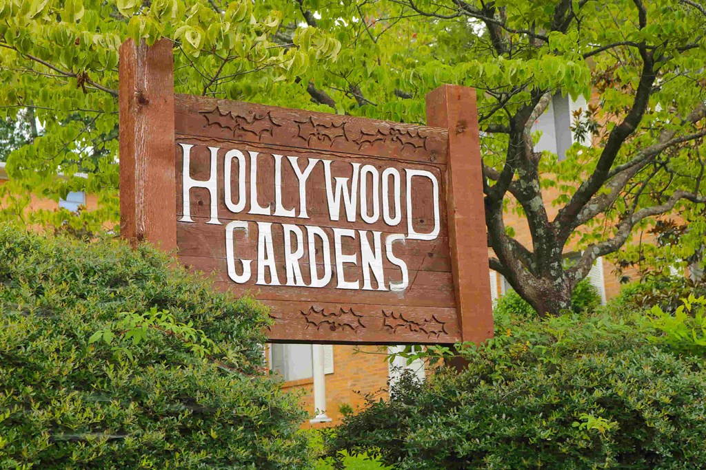 a sign for hollywood gardens in front of a building