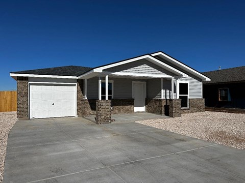 a house with a driveway and a white garage door