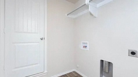 an empty room with a white door and a white wall