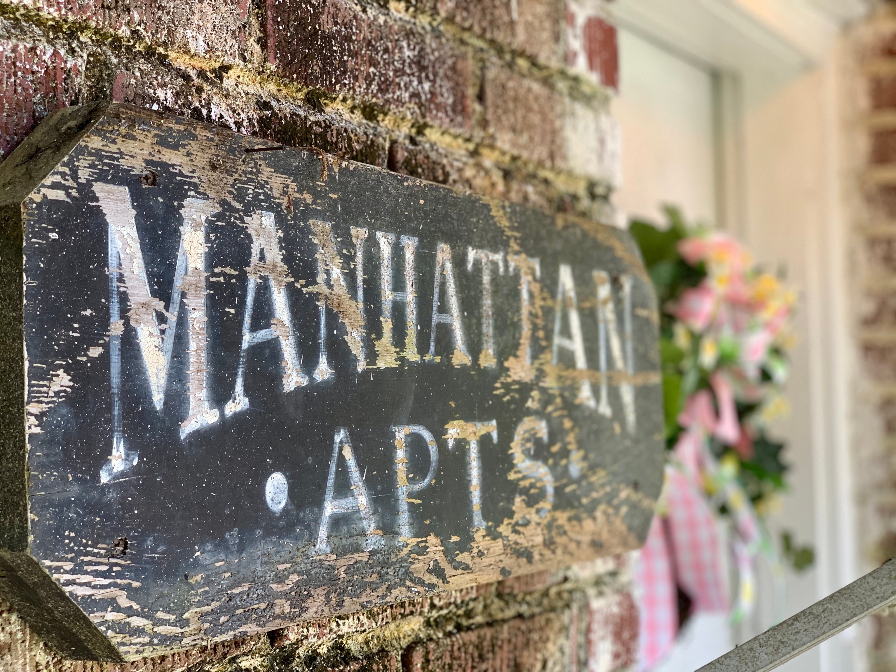a sign on a brick wall that reads nathan apts