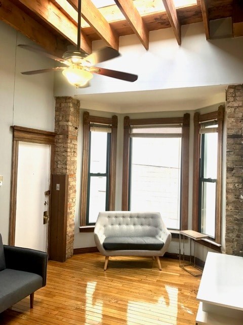 A living room with a white couch and a grey chair.