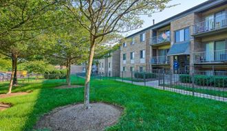 our apartments have a spacious courtyard with green grass and trees