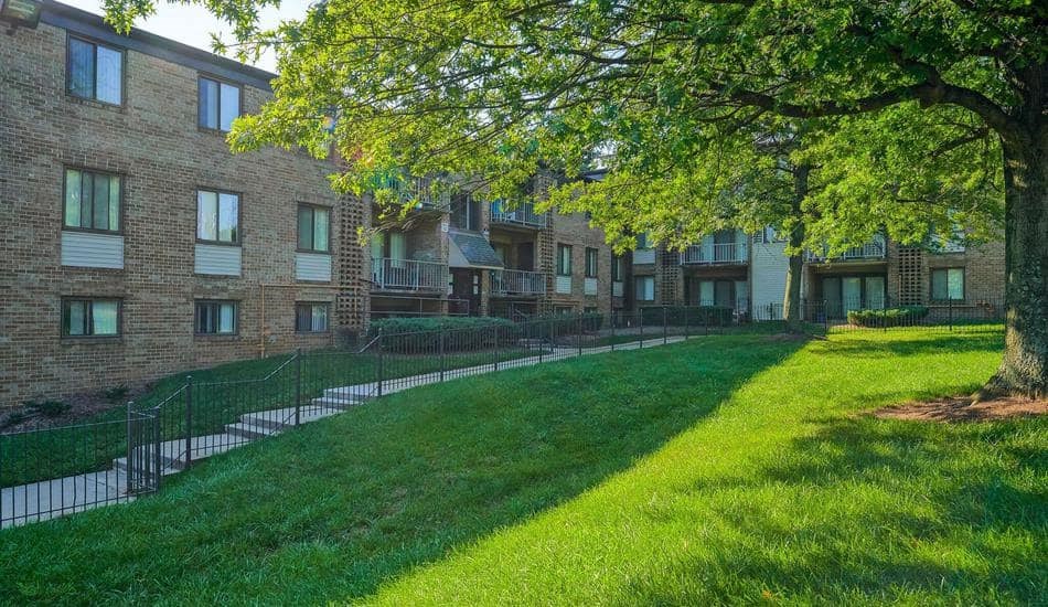 a green lawn in front of a brick building