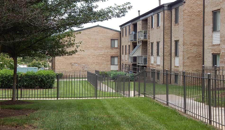 an apartment building with a wrought iron fence