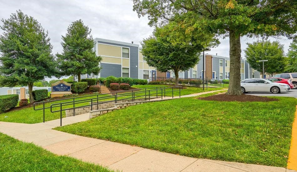 a city street with a building and a park
