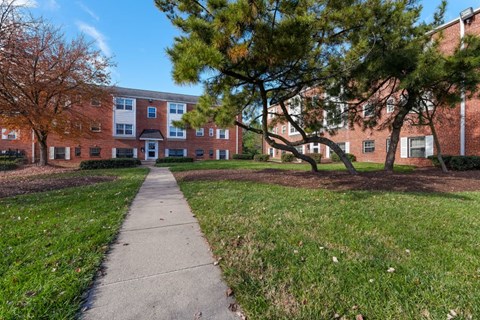 a sidewalk in front of a brick building
