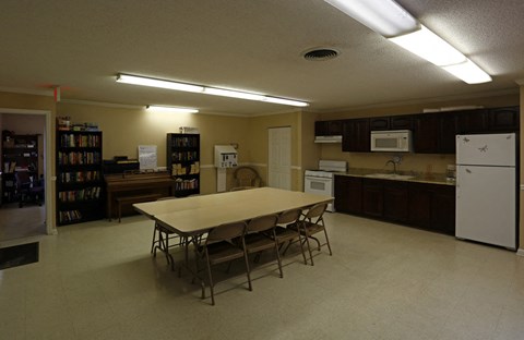 an empty kitchen with a table and chairs in the middle