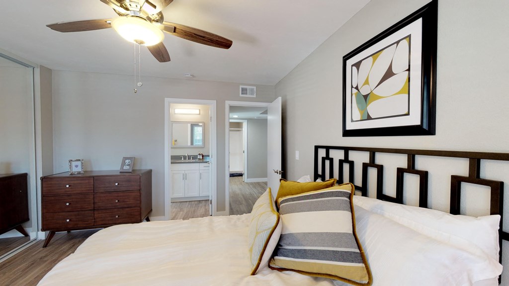 a bedroom with a bed and a ceiling fan