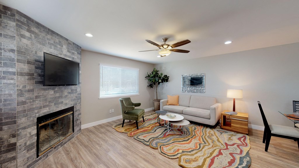 a living room with a couch and a tv and a fireplace