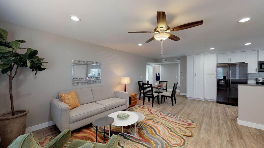 a living room with a couch and a ceiling fan
