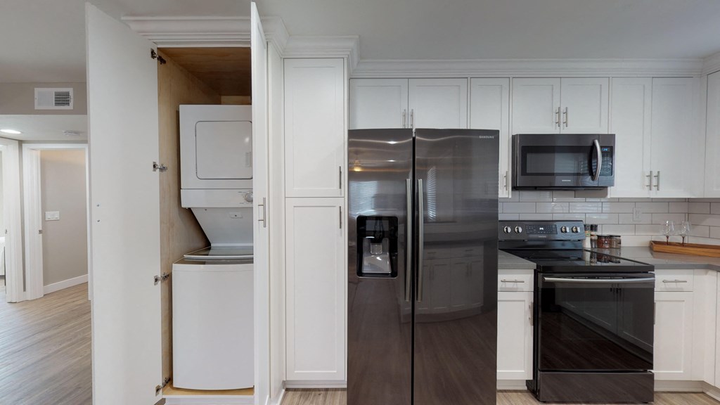 a kitchen with stainless steel appliances and white cabinets