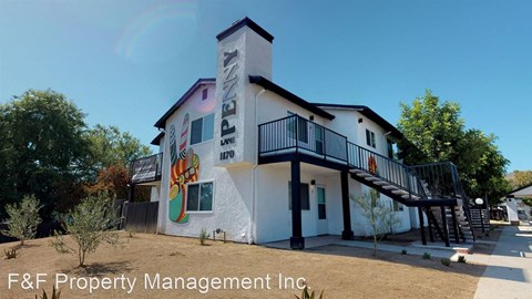 the facade of a building with a mural on the side