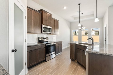 a kitchen with wooden cabinets and stainless steel appliances