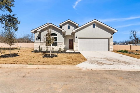 a white house with a garage and a driveway