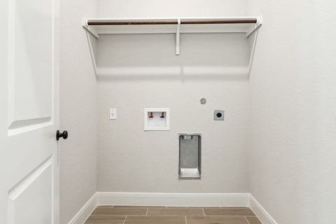 the living room of a home with a white wall and a white door