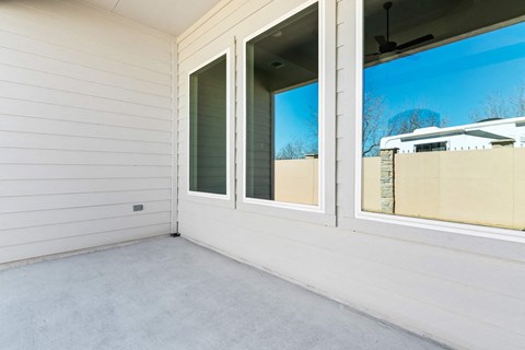 the screened in porch of a manufactured home with large windows